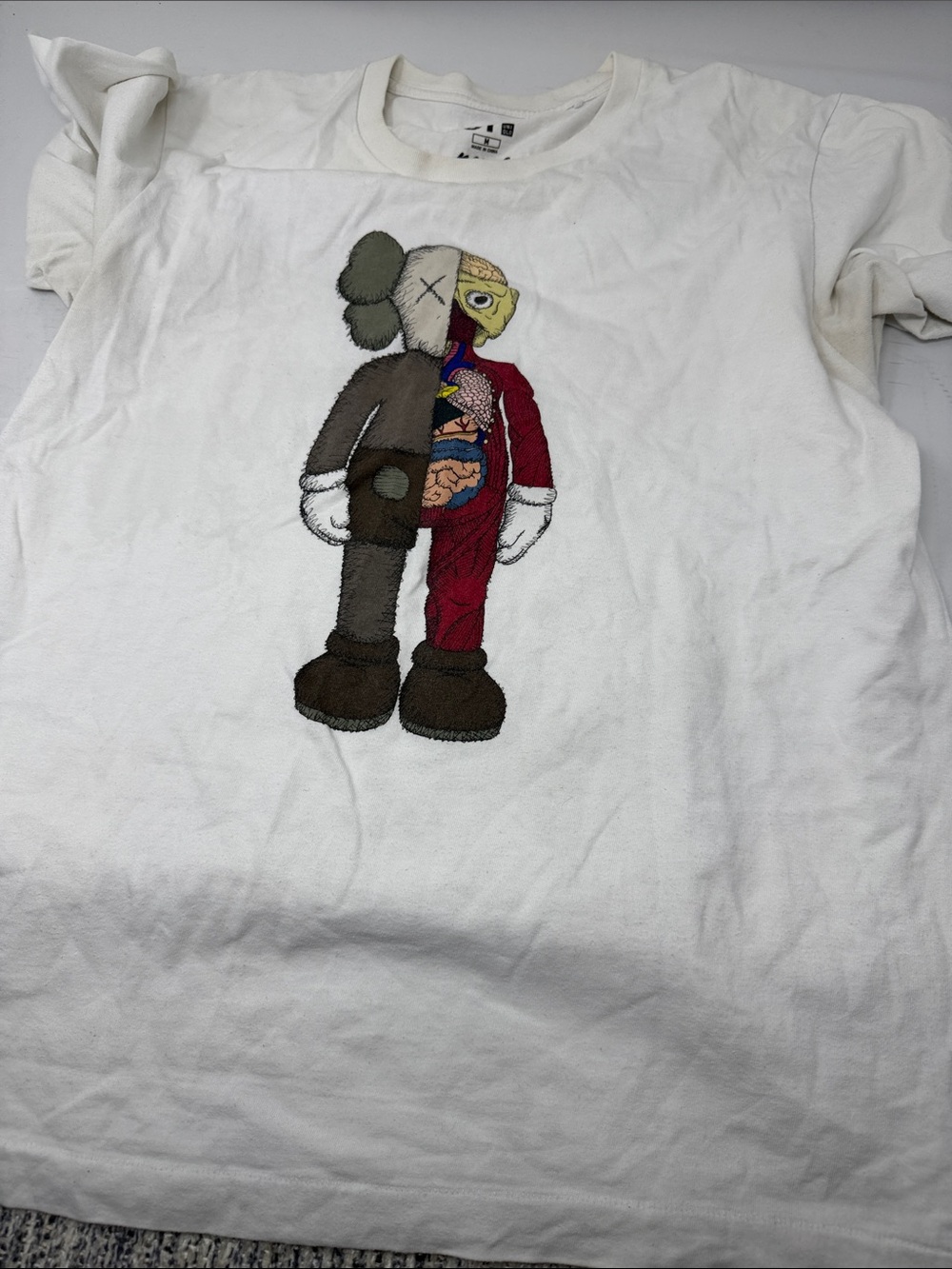 KAWS White Kids Tee with Gray, Brown, Red and Yellow Split-Character Graphic